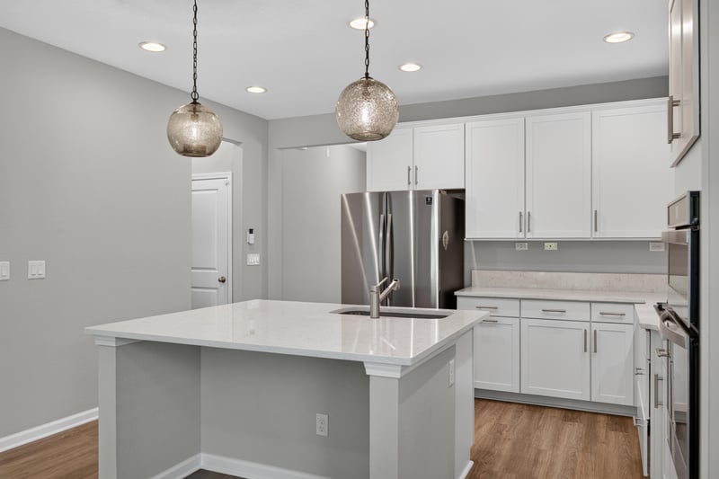 Kitchen island with pendant lights and wood floor at 75875 Saffron Ln, Yulee, FL 32097