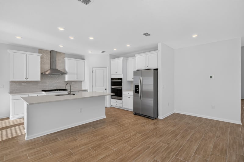 Kitchen island and white cabinetry at 269 Bluegrass Wy, St. Augustine, FL 32092