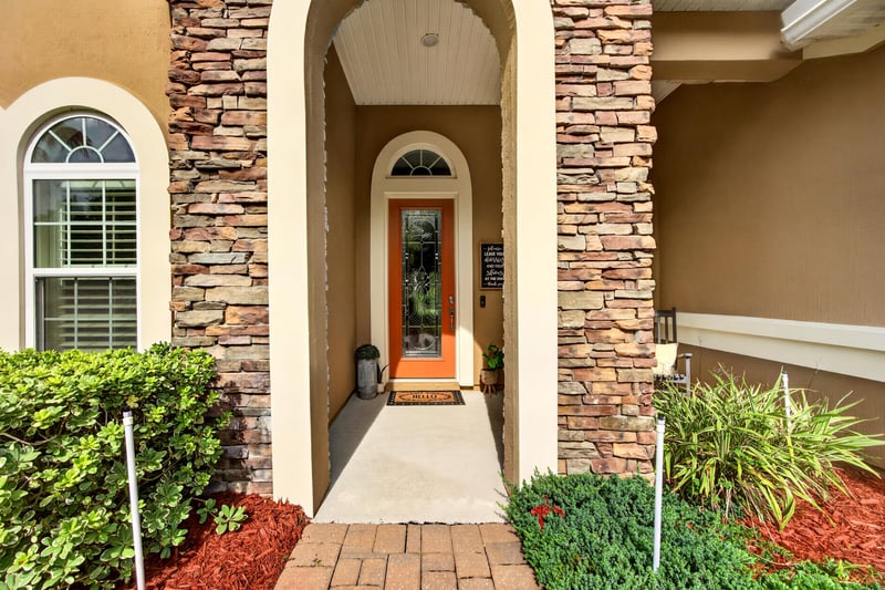 Covered front entry with stone columns and arched window at 276 Cross Ridge Dr, Ponte Vedra Beach, FL 32081