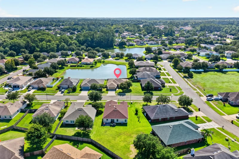 Aerial view marking the home's location by a pond at 7545 Lirope St, Jacksonville, FL 32244