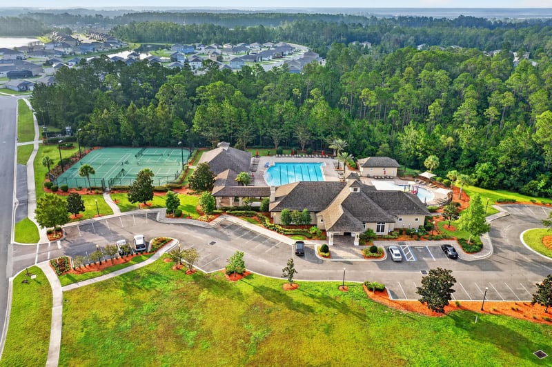 Drone view of community pool and tennis courts in River Glen