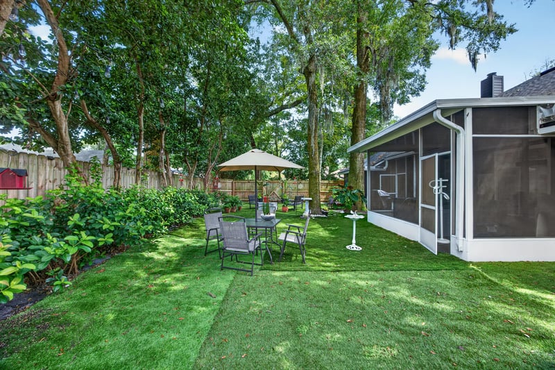 Screened patio with seating and string lights at 1346 Gately Ct, Jacksonville, FL 32225