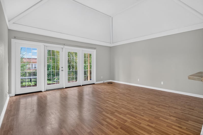 Living room with French doors and vaulted ceiling at 3866 Campenero Ct unit 6, Jacksonville, FL 32217