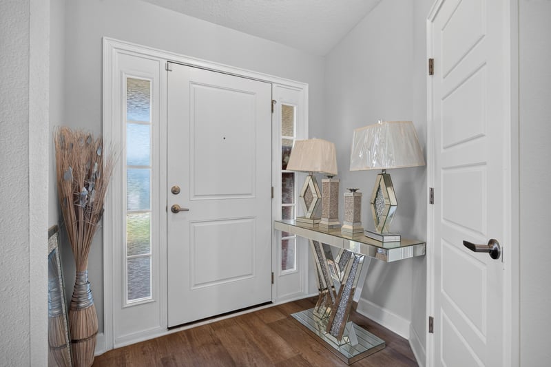Foyer with wood flooring and front door at 9846 Olivia St, Jacksonville, FL