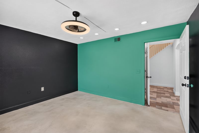 Bedroom with teal accent wall and dark walls at 3428 Glenn Hollow Ct, Jacksonville, FL 32226