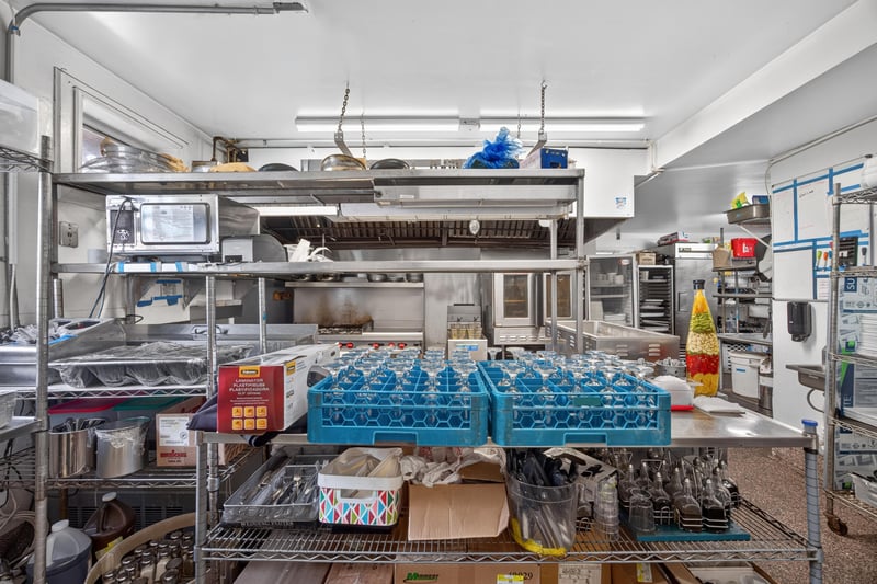 Commercial kitchen with stainless steel prep tables at 115 Cordova St, St. Augustine, FL