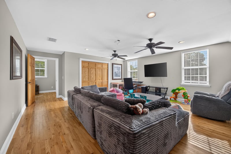 Bonus room with sectional sofa and hardwood floors at 1735 Hagans Ridge Ct