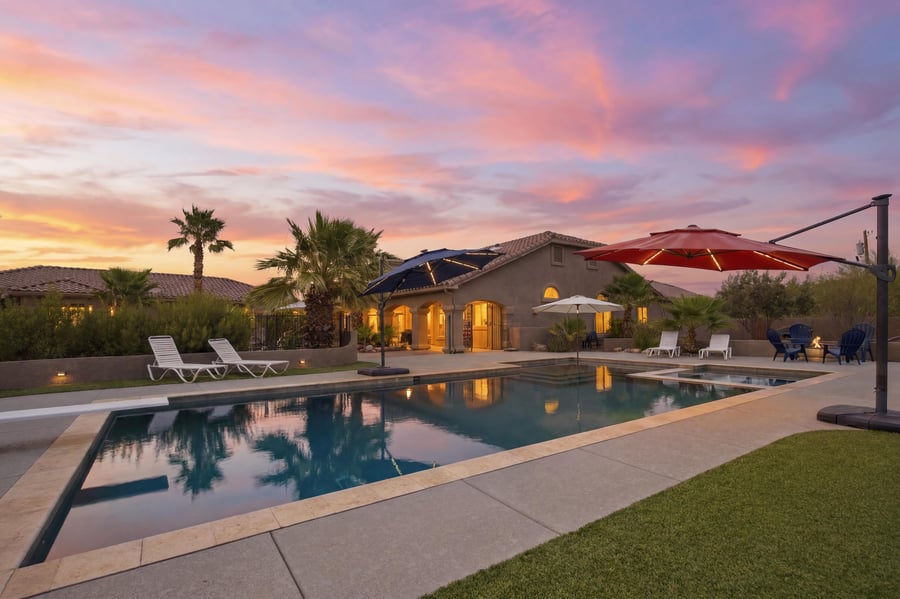 Virtual twilight of a backyard pool under a pink sky