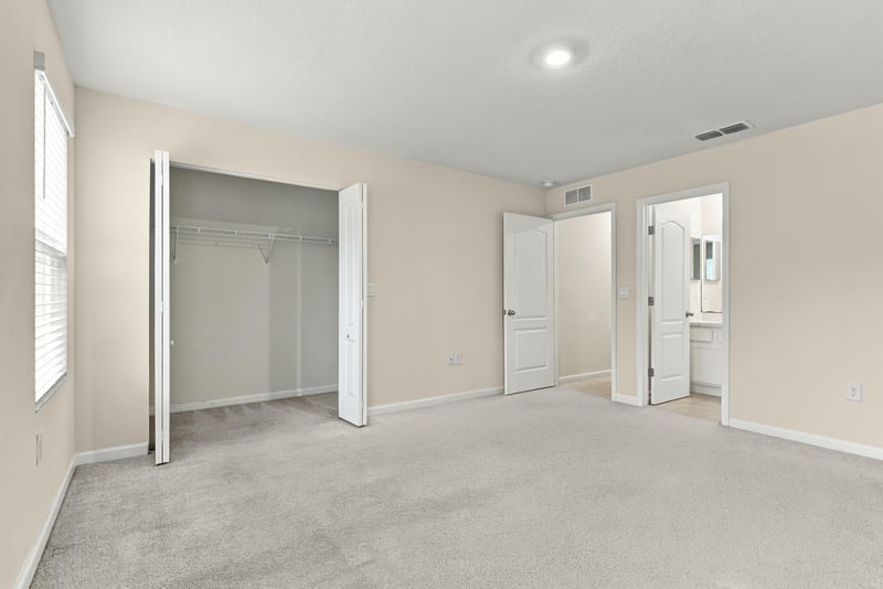Empty bedroom with closet and carpeted floor at 9555 Star Dr, Jacksonville, FL 32256