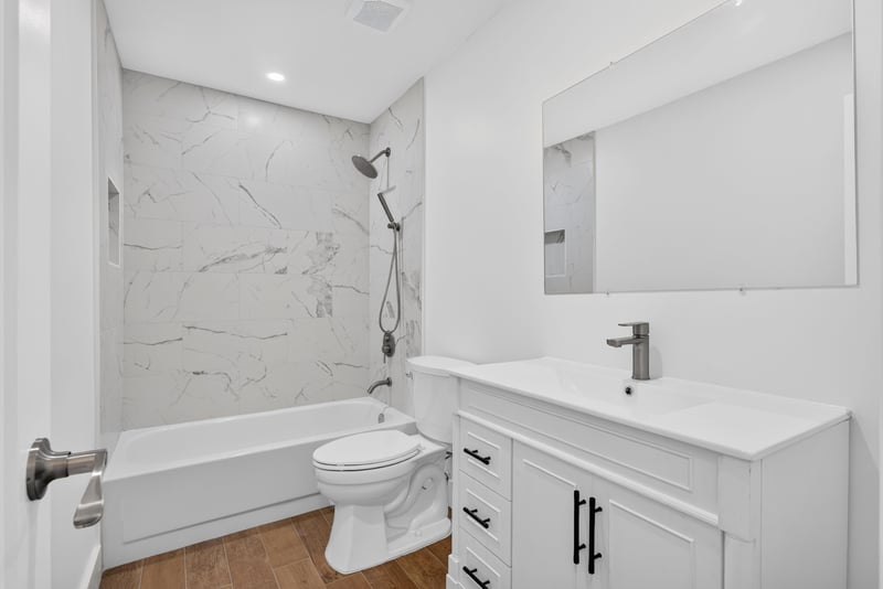 Bathroom with soaking tub and marble-look surround at 8453 Boysenberry Ln W, Jacksonville, FL