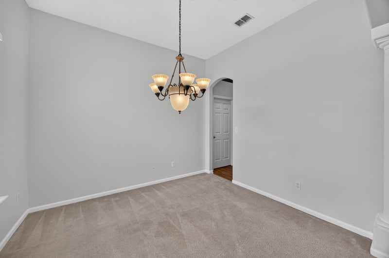 Dining area with chandelier and carpet flooring at 2480 Ridge Will Dr, Jacksonville, FL 32246