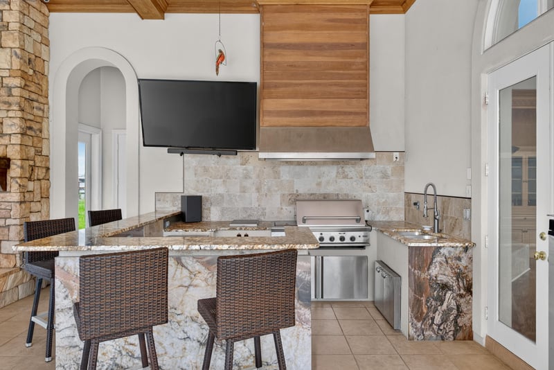 Outdoor kitchen with grill and wood ceiling at 344 Broward Rd, Jacksonville, FL