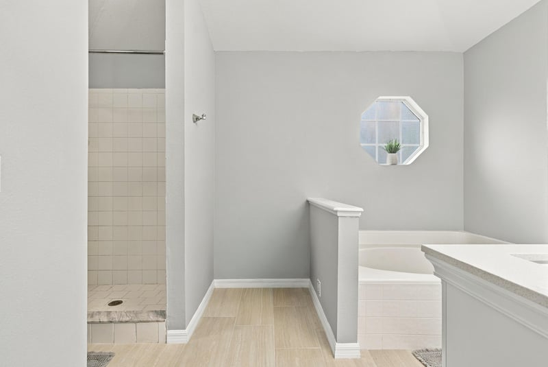 Bathroom with octagon window and tile shower at 11197 Illford Dr