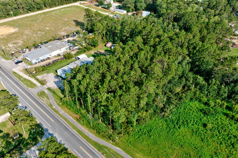 Aerial of the wooded parcel next to mobile homes along the road at 4393 Co Rd 218, Middleburg, FL 32068