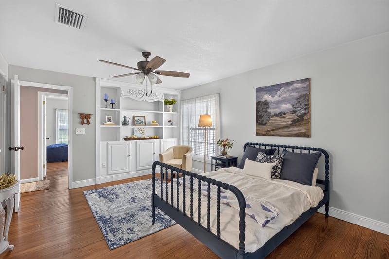 Bedroom with built-in shelving and metal bed frame at 5843 Ovella Rd, Jacksonville, FL 32244