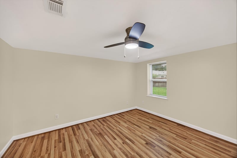 Empty room with wood floors and single window at 1619 Hammond Blvd, Jacksonville, FL