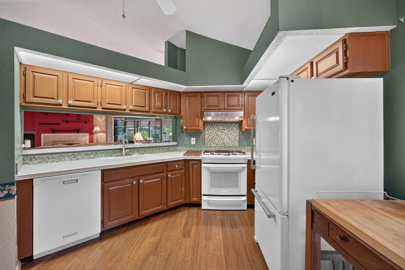 Kitchen with tile countertops and white refrigerator at 4837 Pareja Ct, Jacksonville, FL 32225