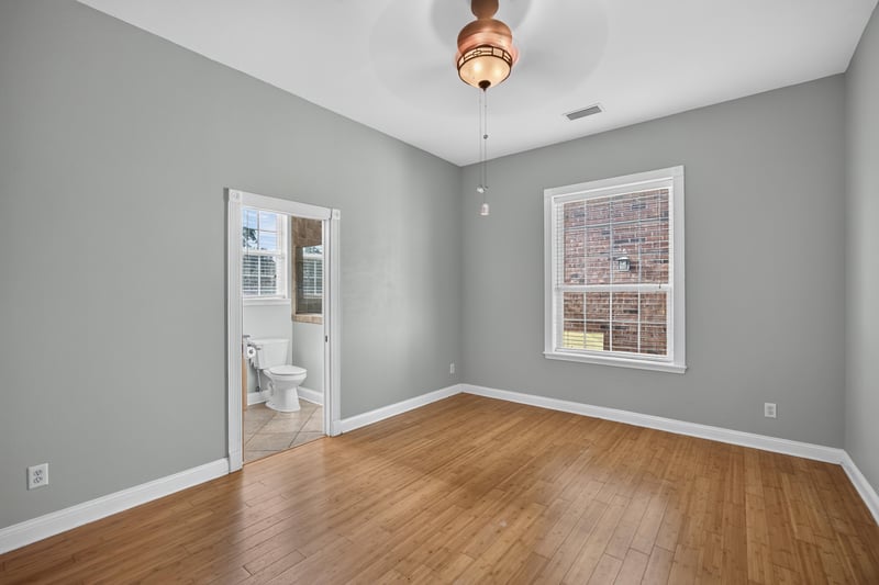 Bedroom staged with bed and windows at 1735 Hagans Ridge Ct