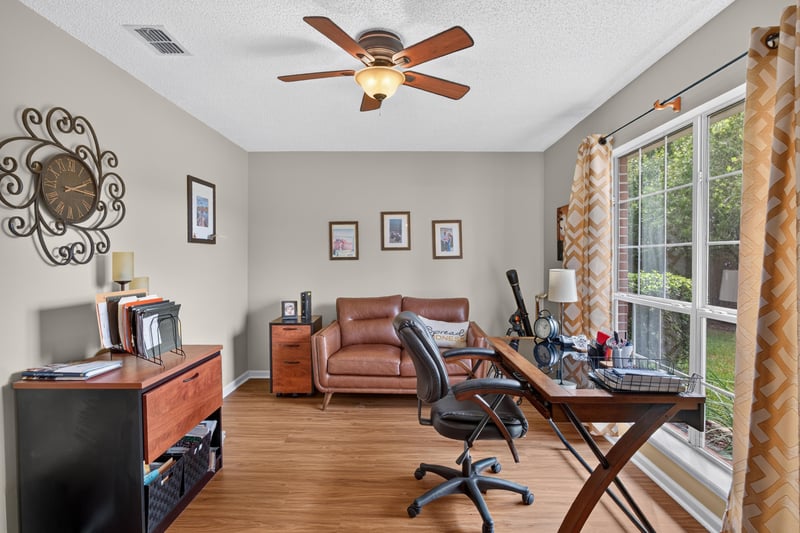 Home office with desk, leather sofa and vaulted ceiling at 13514 Las Brisas Way N, Jacksonville, FL