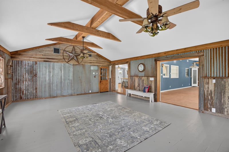 Great room opening to adjoining room through barn doors at 5843 Ovella Rd, Jacksonville, FL 32244