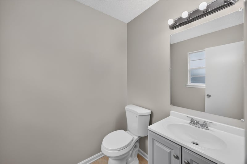 Bathroom with vanity mirror and toilet at 1040 Willow Cove Ct E, Jacksonville, FL 32233