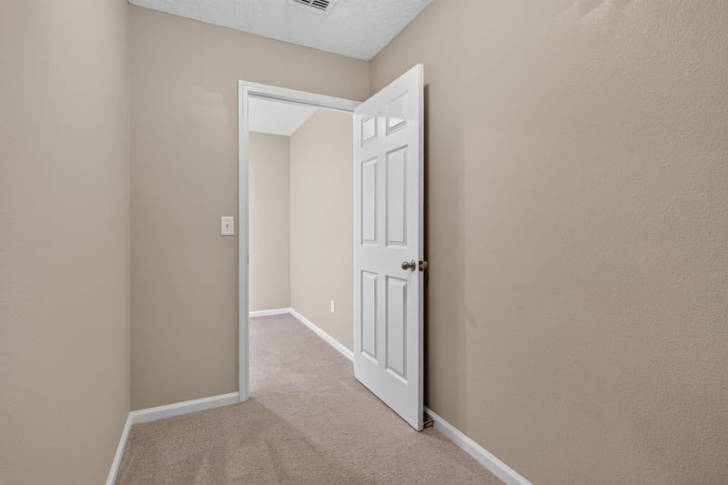 Hallway with door open and carpet at 13685 Goodson Pl, Jacksonville, FL 32226