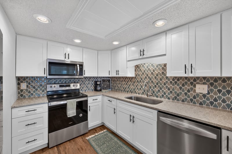 Kitchen with white cabinets and stainless appliances at 2280 Shepard St