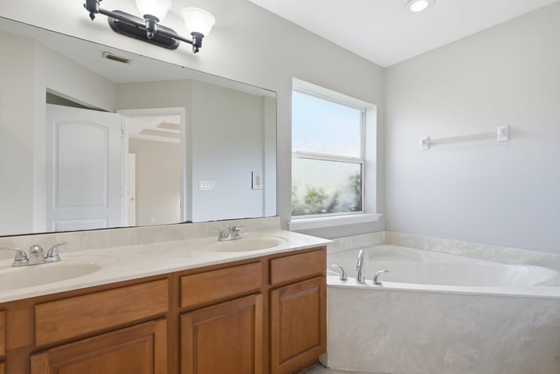 Primary bath with double vanity and soaking tub at 14187 Big Spring St, Jacksonville, FL 32258