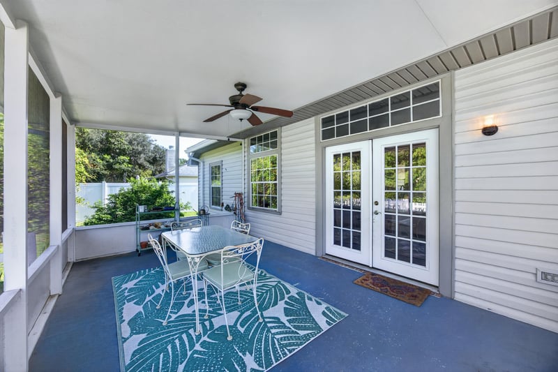 Screened porch with table and french doors at 11828 Heather Grove Ln, Jacksonville, FL