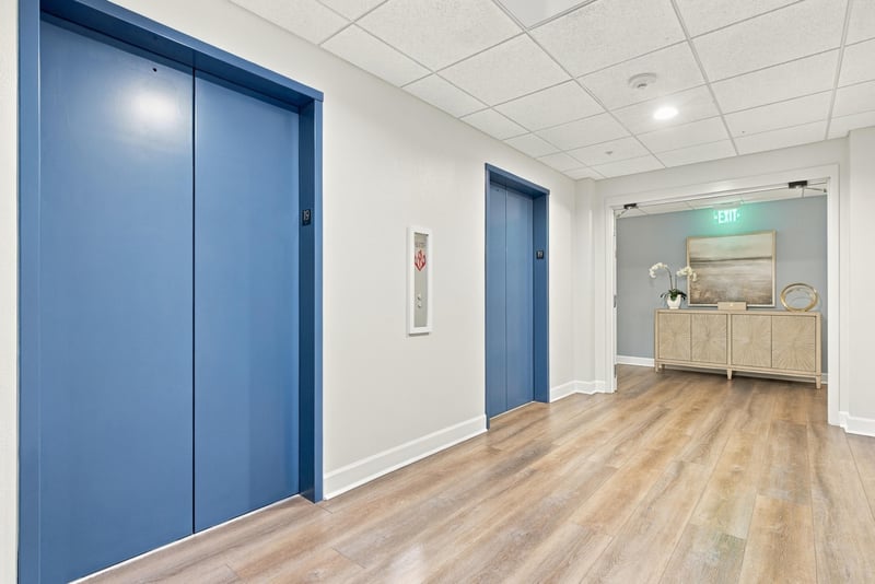 Hallway with blue accent doors in San Marco Place