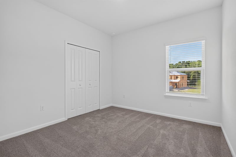 Empty carpeted bedroom with closet at 269 Bluegrass Wy, St. Augustine, FL 32092
