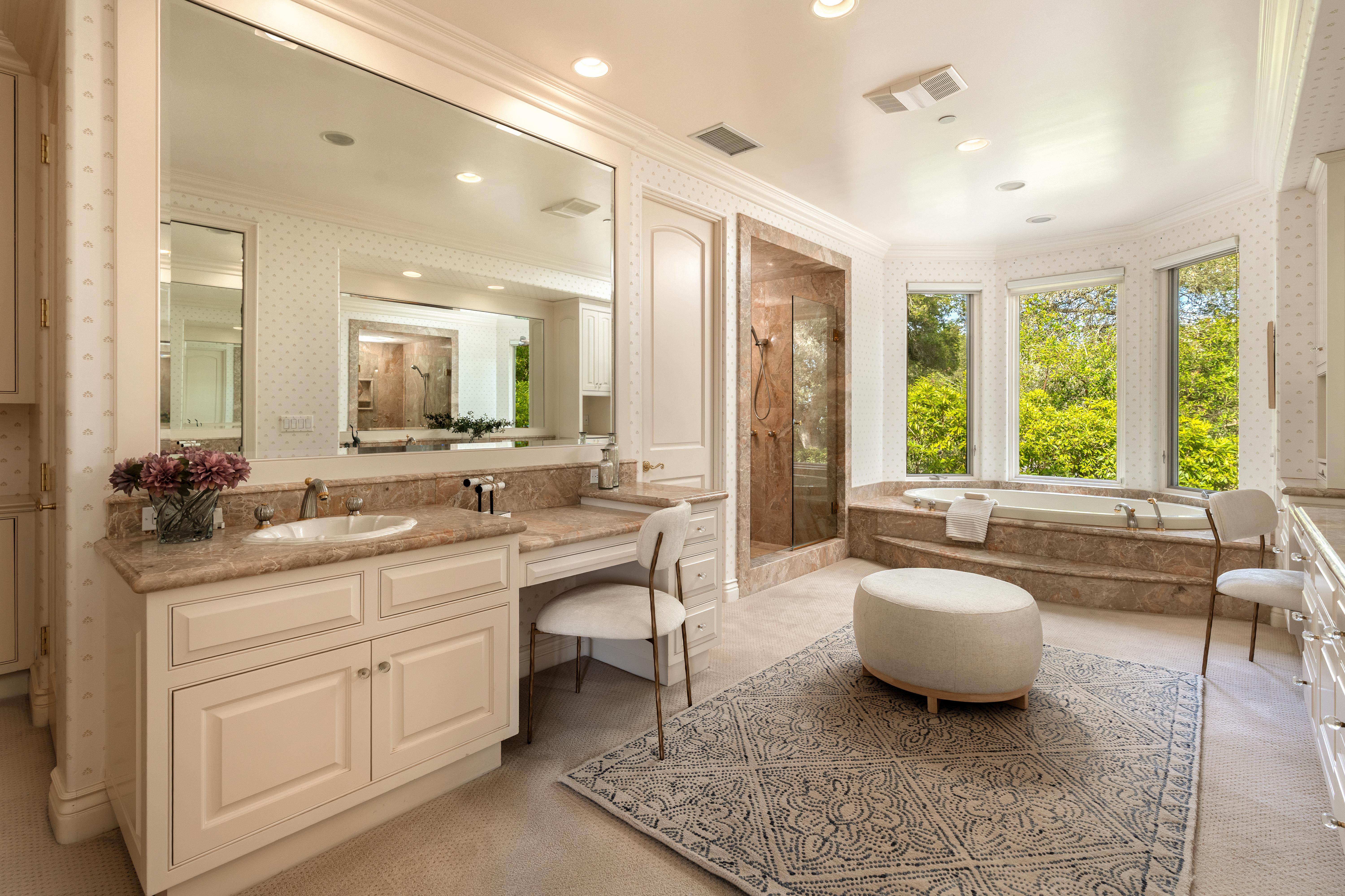 Aerial drone photography of hilltop estate at 450 El Cielito Rd, Santa Barbara — real estate drone photography revealing roofline, mature landscaping, and sweeping Pacific Ocean and Channel Islands panorama above the American Riviera. Our team captured still photography, aerial drone photography, twilight photography, a Matterport virtual tour, a 2D floor plan, and a custom property website from afternoon through twilight.