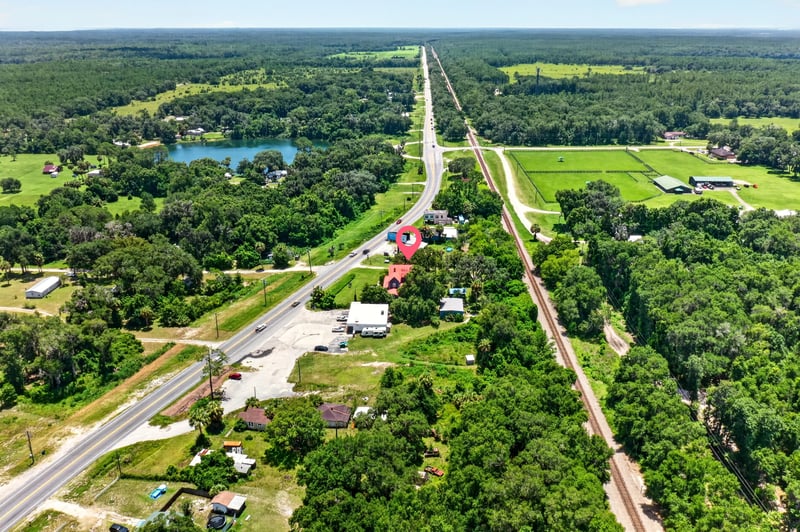 Aerial view along US-17 showing the property among rural fields in Satsuma, FL