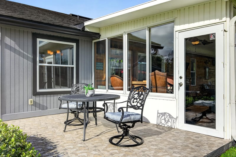 Back patio with table and chairs at 6931 Cane Grass Ln E, Jacksonville, FL 32244