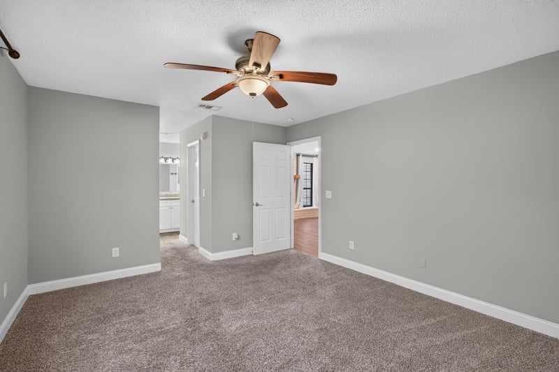 Carpeted bedroom with closet doors at 12344 Cormorant Ct, Jacksonville, FL