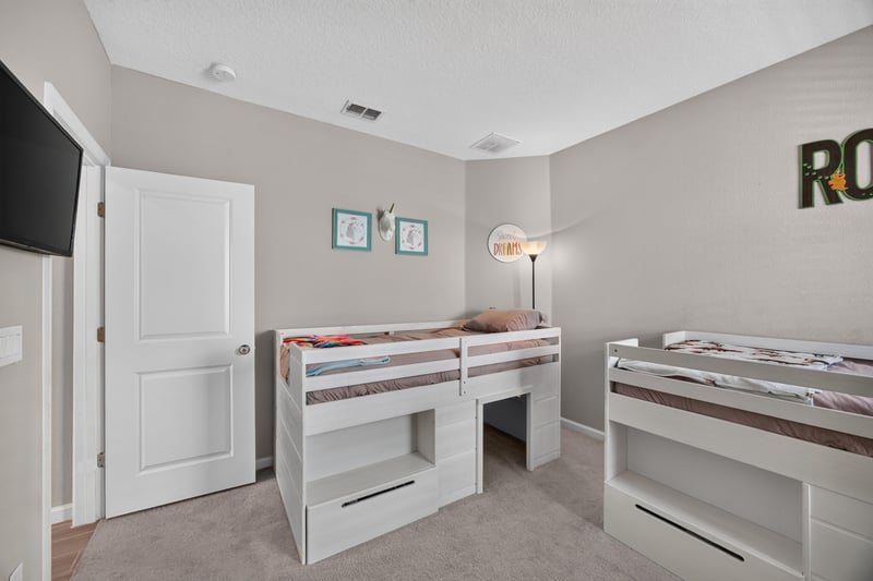 Bunk bed room with ceiling fan at 9942 Lovage Ln, Jacksonville, FL 32219