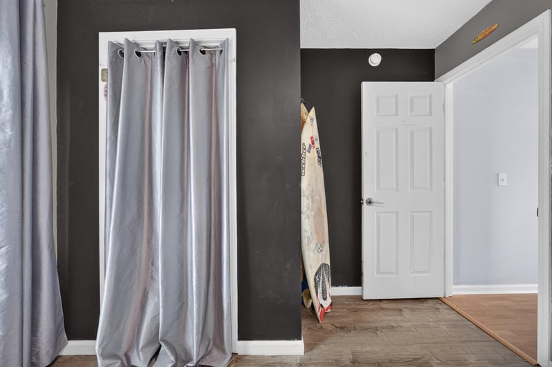 Closet with surfboard and dark accent wall at 4556 Shaky Leaf Ln N, Jacksonville, FL 32224