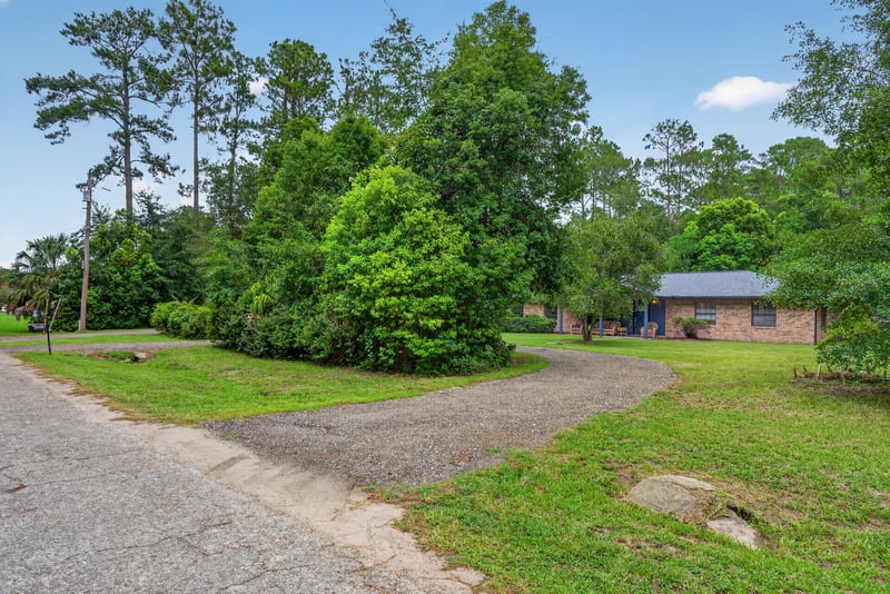 Driveway view with trees and home in background at 3249 Maryland Ave, Green Cove Springs, FL