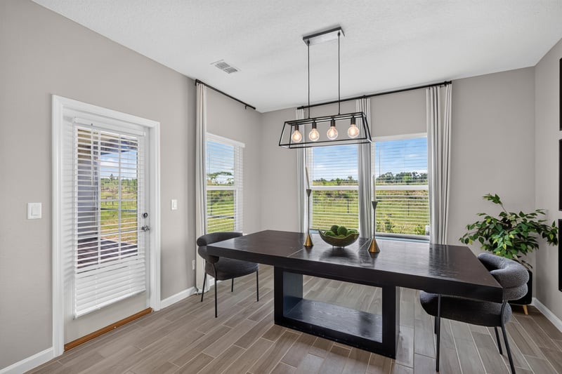 Dining nook with windows and pendant light at 9942 Lovage Ln, Jacksonville, FL 32219