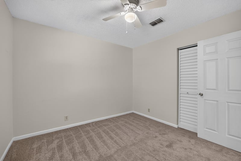 Bedroom with ceiling fan and closet door at 2829 Blackberry Ave