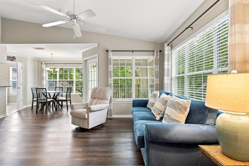 Living and dining area with large windows and ceiling fan at 7800 Point Meadows Dr, Jacksonville, FL 32256