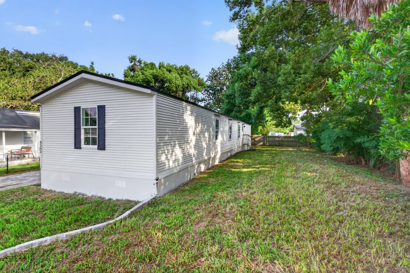 Side yard with grass and trees at 4565 Appleton Ave, Jacksonville, FL