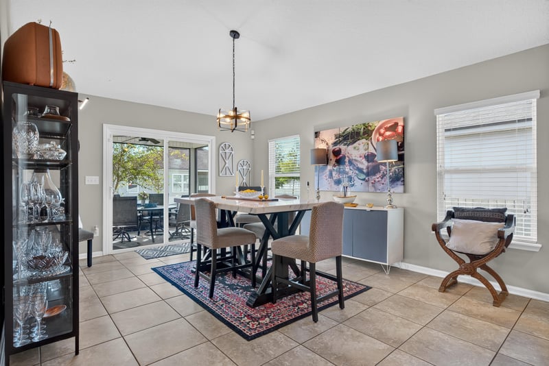 Dining area with chandelier and glass cabinet at 589 Seville Pkwy, St. Augustine, FL
