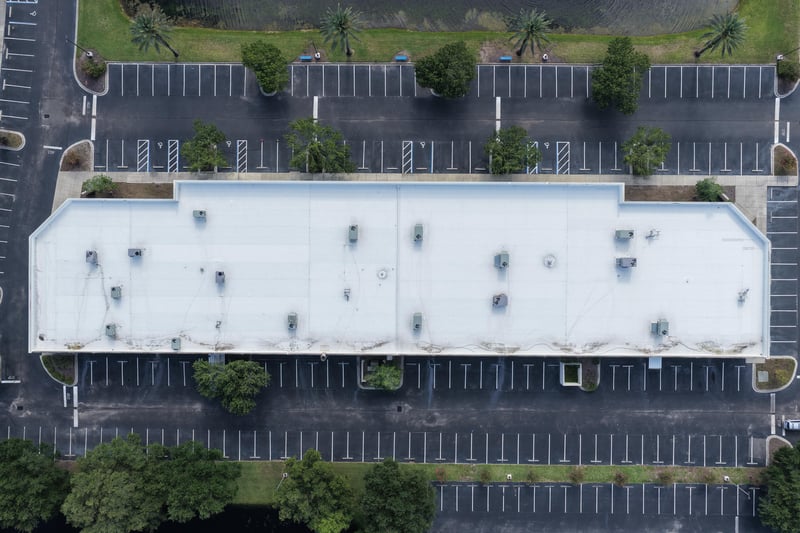 Aerial view of a long building roofline with parking at 10550 Deerwood Park Blvd, Jacksonville, FL 32256