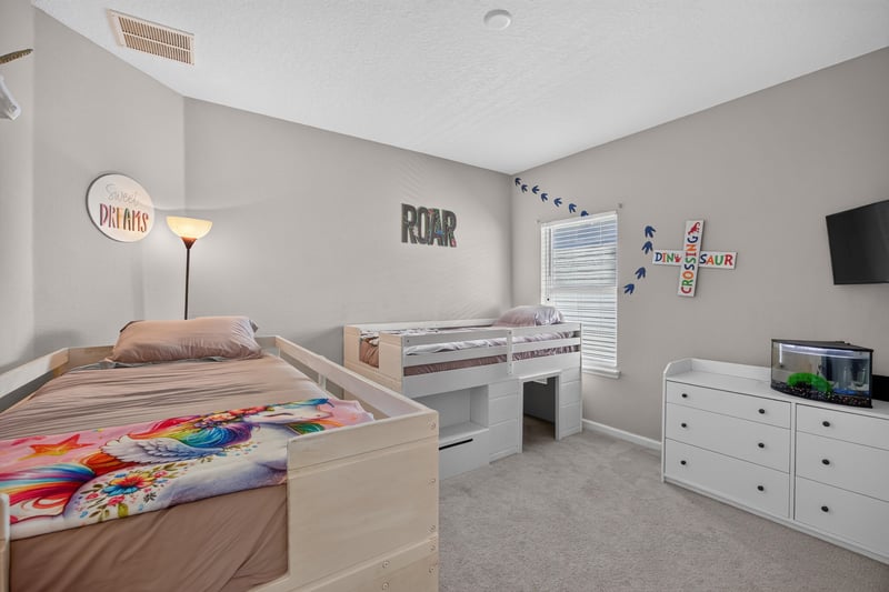 Bedroom with bunk beds and ROAR wall decal at 9942 Lovage Ln, Jacksonville, FL 32219