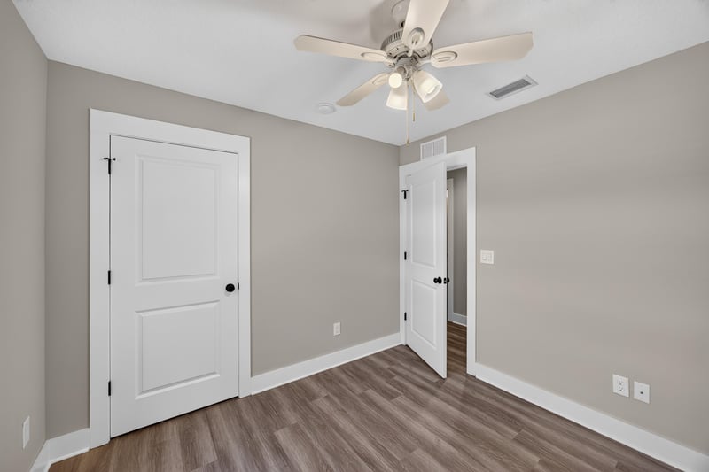 Bedroom with closet doors and wood flooring at 2855 N 8th St, St. Augustine, FL 32084