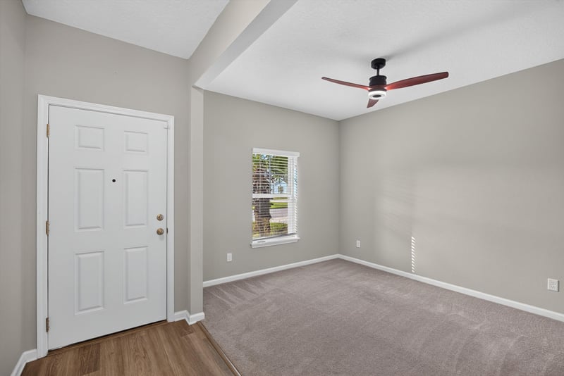 Hallway with carpet, wood floor and ceiling fan at 75875 Saffron Ln, Yulee, FL 32097