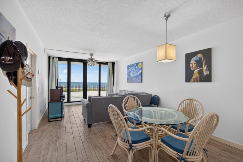 Living and dining area with ocean view through sliders at 601 1st St S, Jacksonville Beach