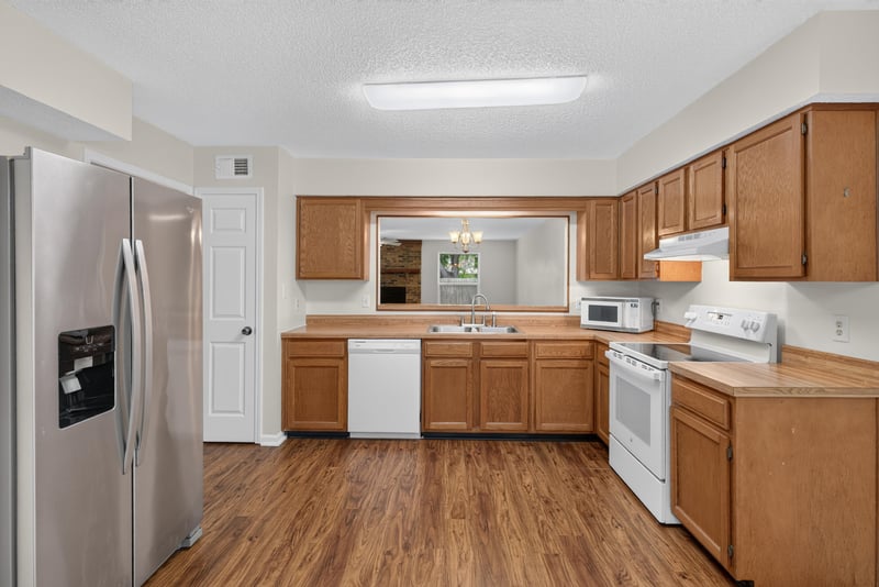 Kitchen with stainless refrigerator and oak cabinets at 4427 Millstone Ct, Jacksonville, FL