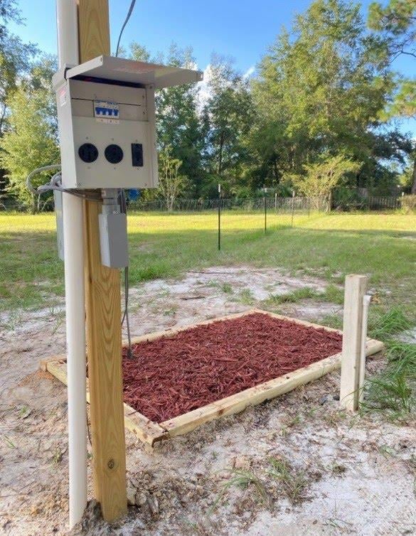 Utility box on a post with a mulch bed at 4890 McAllister Rd, Middleburg, FL 32068